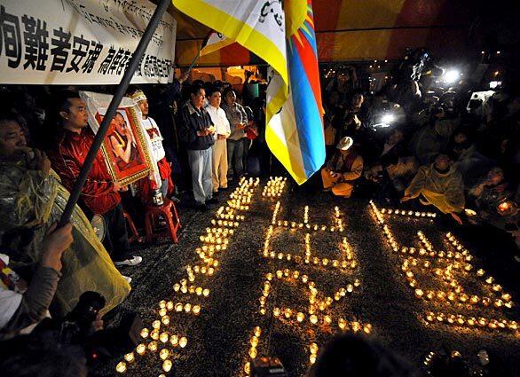 Tibetan monks and others gather outside the presidential palace in Taipei for a candlight vigil to protest the Chinese crackdown in Tibet.