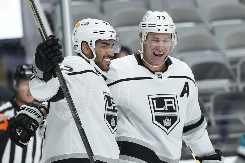 Los Angeles Kings left wing Andreas Athanasiou (22) celebrates with center Jeff Carter (77) after scoring a goal.
