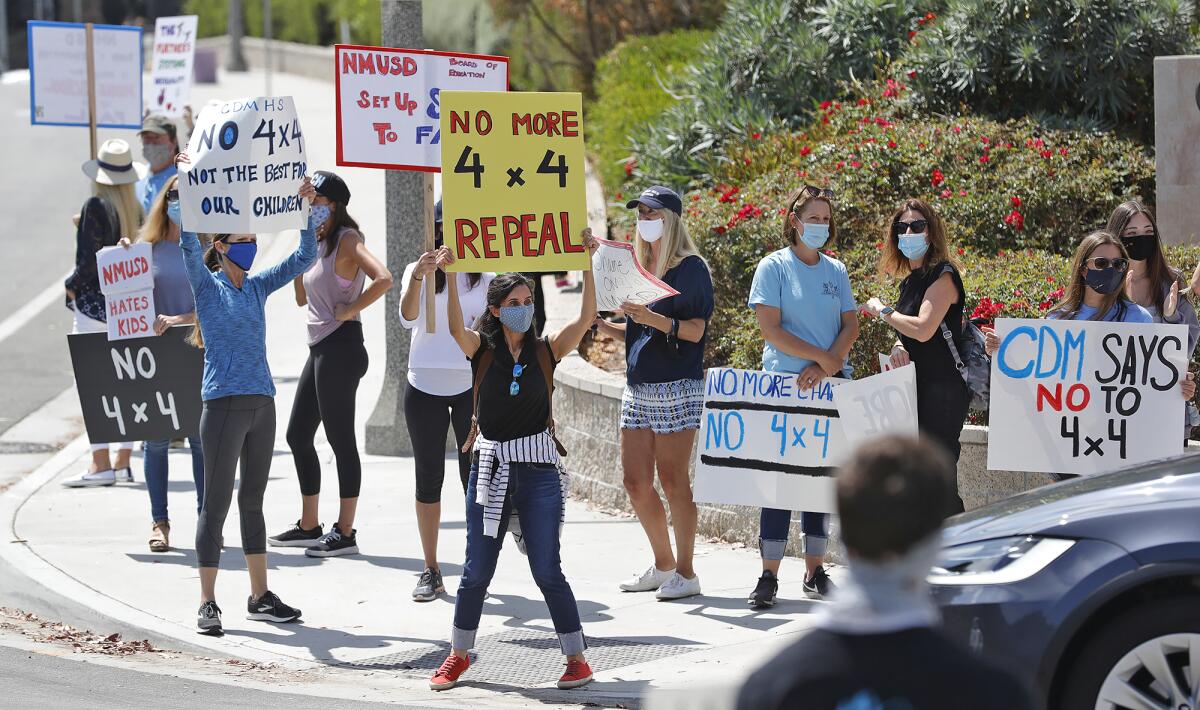 Unhappy parents and teachers protest against the 4x4 learning schedule in front of Corona del Mar High School on Monday.