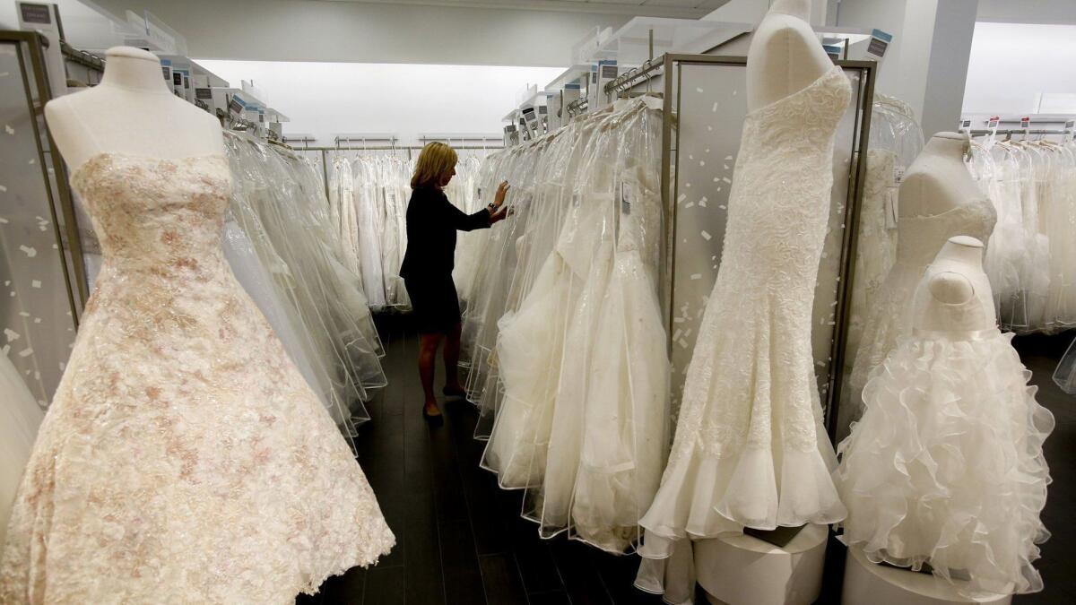 A store manager searches through gowns at a David's Bridal store in Los Angeles in 2014.
