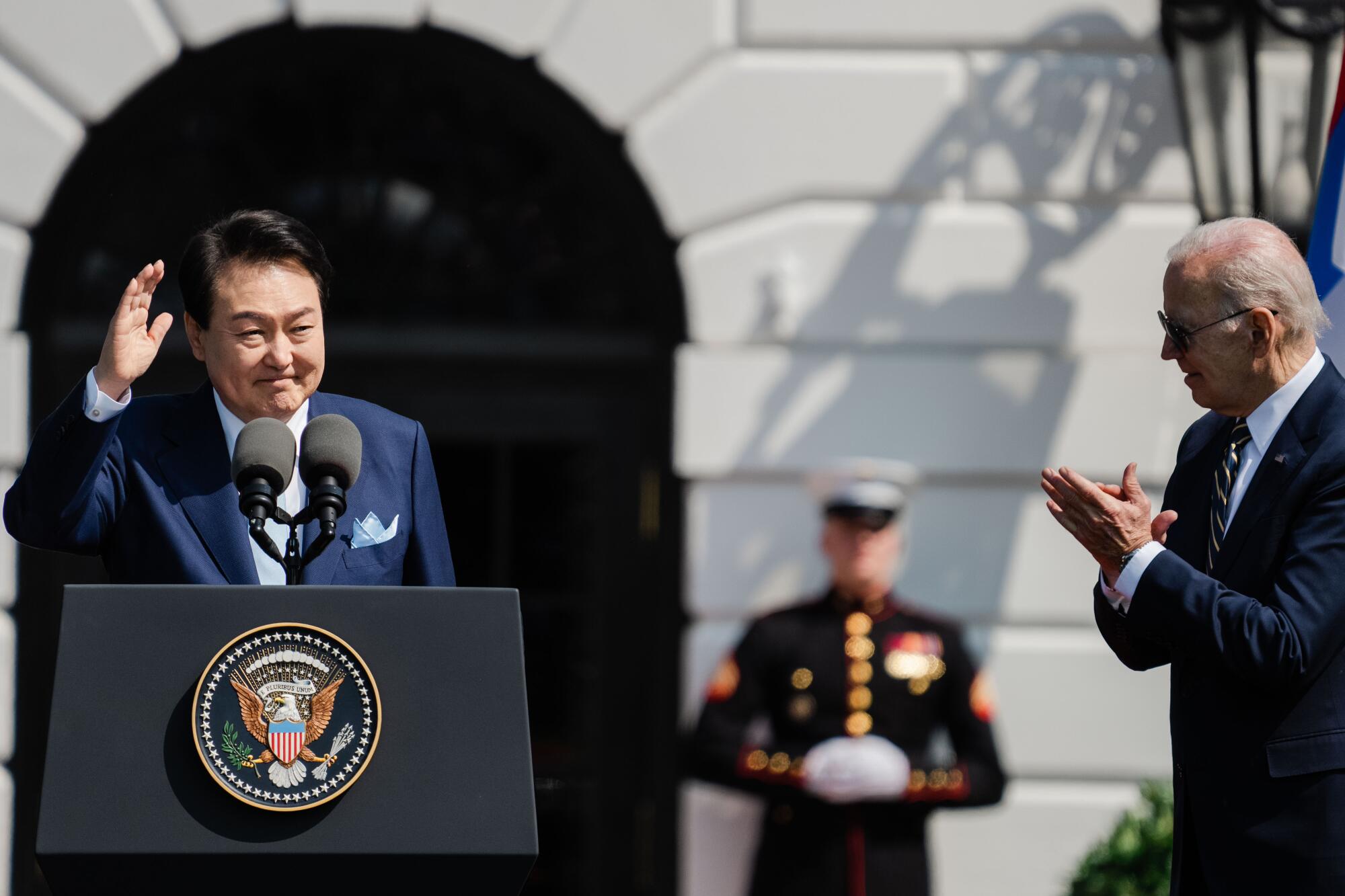 South Korean President Yoon Suk Yeol speaks as President Joe Biden listens at the South Lawn of the White House