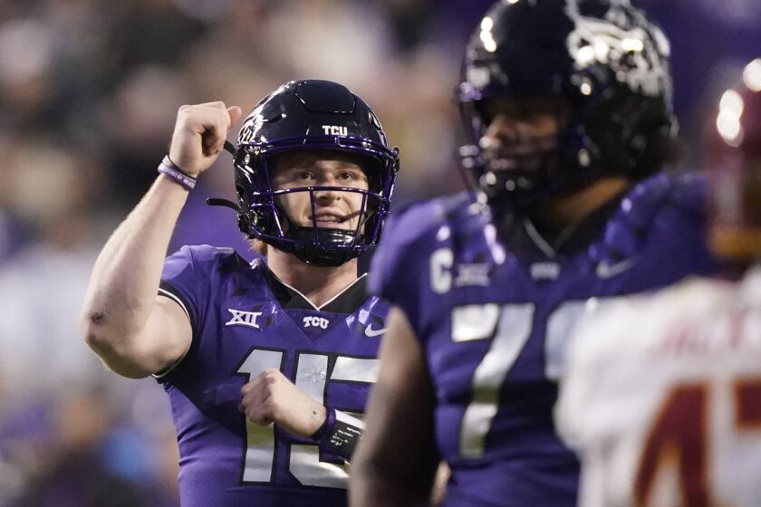 TCU quarterback Max Duggan reacts to throwing touchdown pass during the second half of an NCAA college football game against Iowa State in Fort Worth, Texas, Saturday, Nov. 26, 2022. TCU won 62-14. (AP Photo/LM Otero)