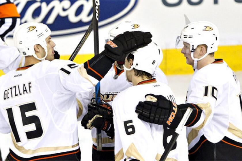 Ryan Getzlaf, Ben Lovejoy and Corey Perry celebrate a goal on the Oilers during the third period of the Ducks' 3-1 victory over Edmonton on Sunday.