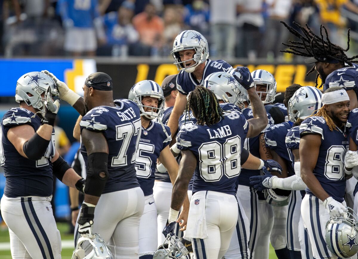 The Cowboys celebrate and hoist  Greg Zuerlein after the kicker's 56-yard field goal won the game. 