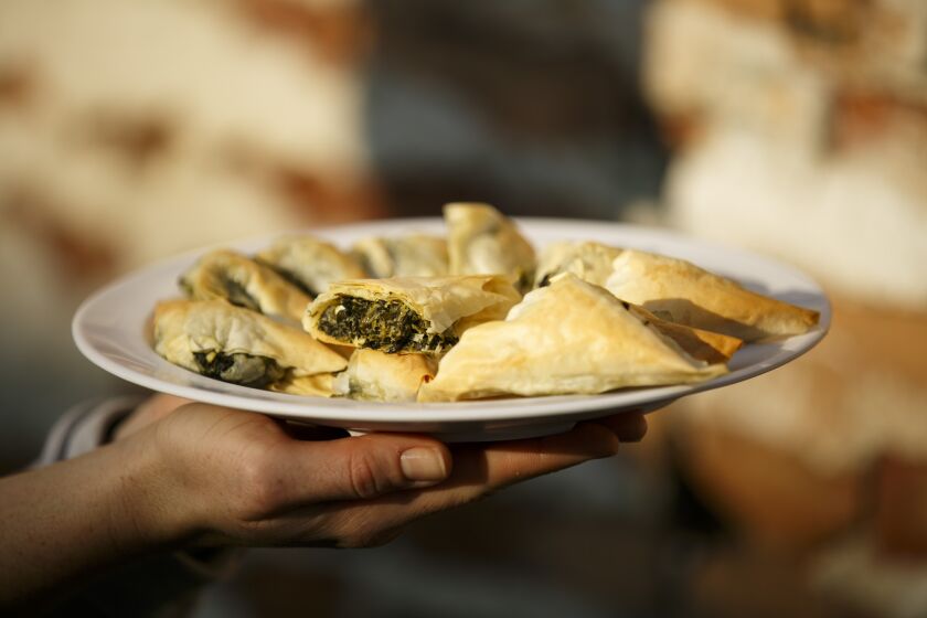 Spanakopita, a dish with thin flaky filo, spinach, Greek feta cheese, onion, dill, extra virgin olive oil, Greek seasoning, served at Papa Cristo's.