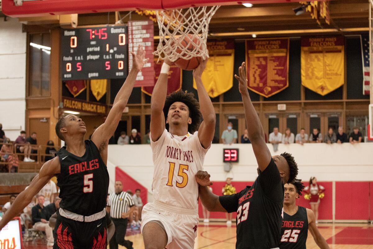 Torrey Pines' Aidan Fowler attempts to score between Etiwanda's Jimmy Baker (5) and Marcus Green (23).