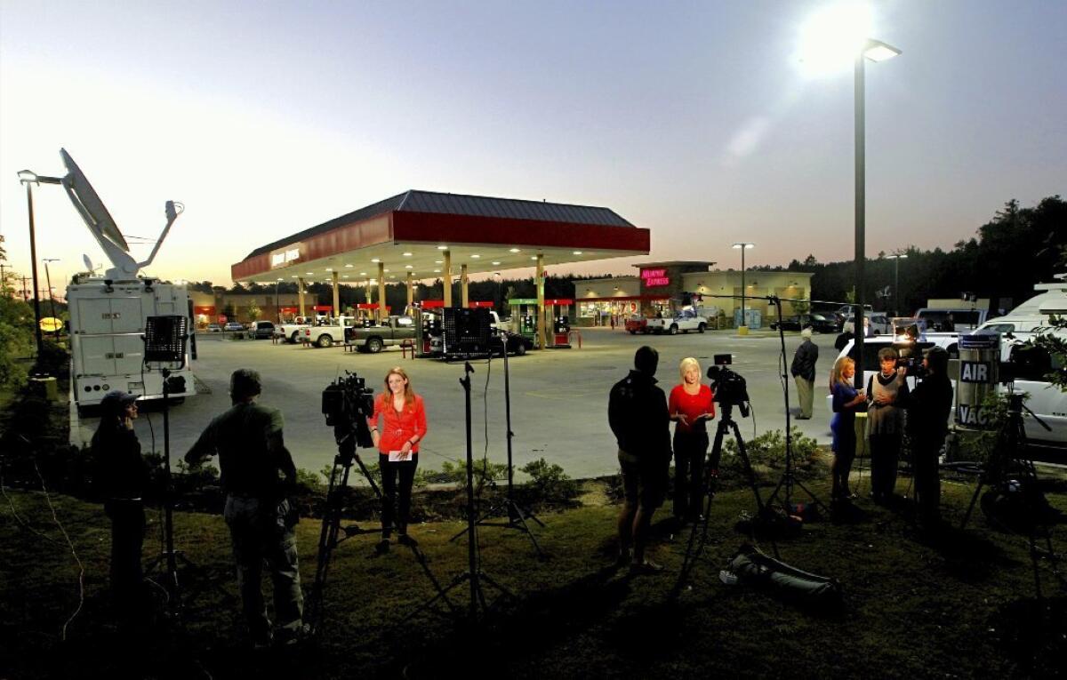 TV journalists report from a gas station in Lexington, S.C., in 2013, where a winning Powerball ticket was sold in 2013.