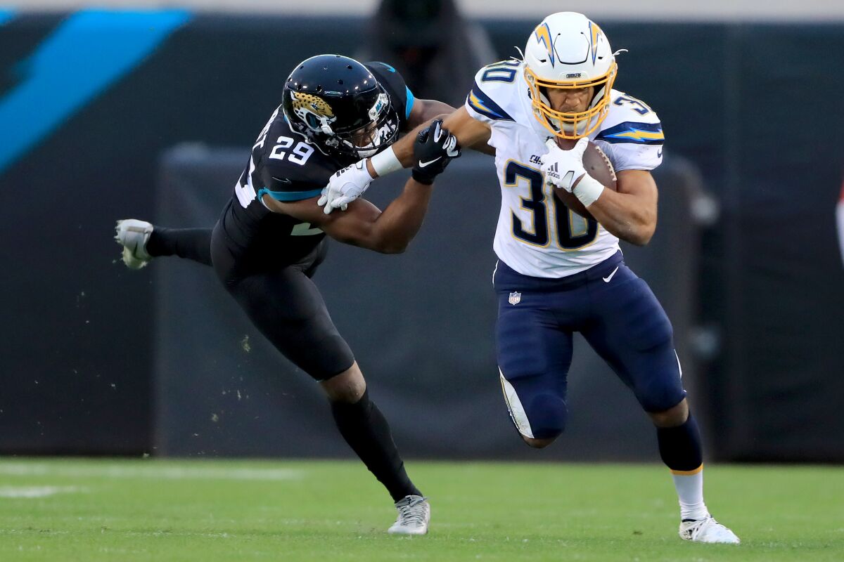 Chargers' running back Austin Ekeler tries to break free of the Jaguars during a game Dec. 8 at TIAA Bank Field. Ekeler needs 108 more yards to reach 1,000 in receiving.