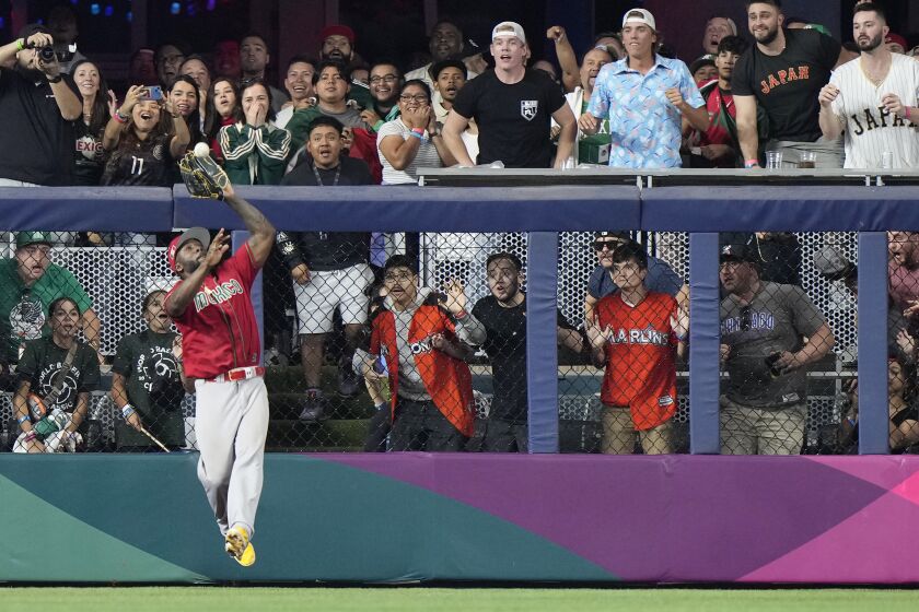 Mexico left fielder Randy Arozarena catches a ball hit by Japan's Kensuke Kondoh during the fifth inning of a World Baseball Classic game, Monday, March 20, 2023, in Miami. (AP Photo/Wilfredo Lee)