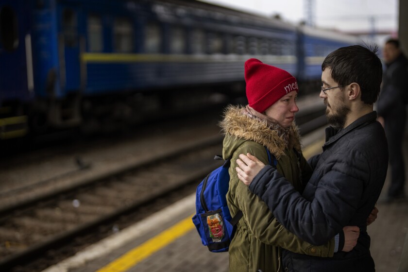 A couple says goodbye before she boards on a train bound for Lviv at the Kyiv station, Ukraine, Thursday, March 3. 2022. (AP Photo/Emilio Morenatti)