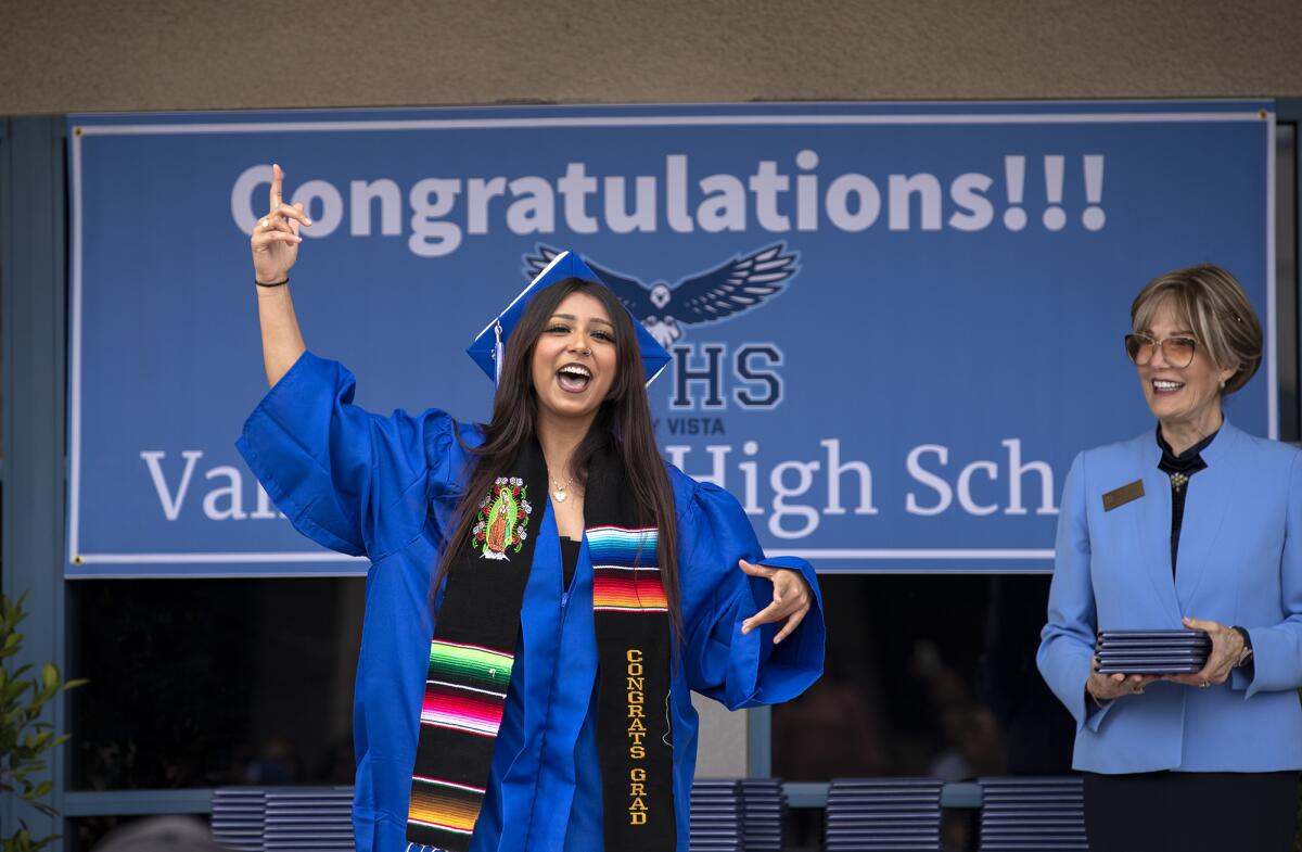 A graduate gestures to the crowd during the commencement ceremony for Valley Vista High School on Thursday.