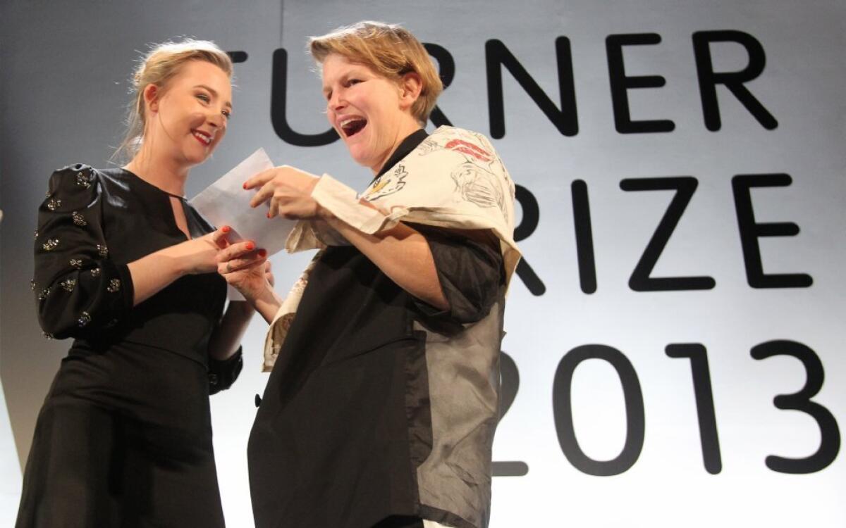 Artist Laure Prouvost, right, accepts the 2013 Turner Prize from actress Saoirse Ronan at Monday's ceremony in Londonderry, Northern Ireland.