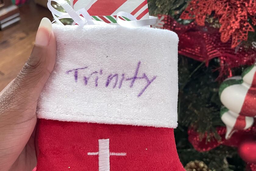 Trinity Alicia hangs her own Christmas stocking last year 2021.