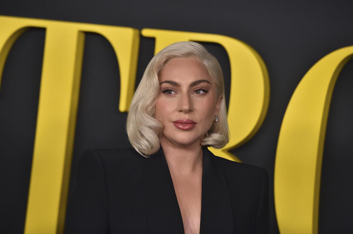 Lady Gaga wearing a black blazer with her hair in a short blond bob