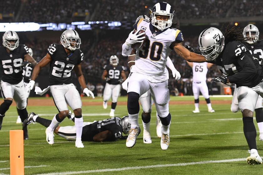 OAKLAND, CALIFORNIA SEPTEMBER 10, 2018-Rams running back Todd Gurley beats the Raiders defense to the end zone inthe 1st quarter at the Oakland Coliseum Monday night. (Wally Skalij/Los Angeles TImes)