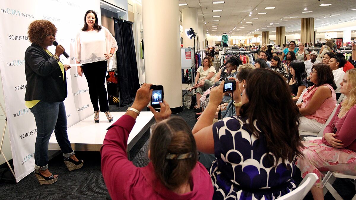 Plus-size fashion blogger Marie Denee, left, hosts a fashion show at Nordstrom in Costa Mesa's South Coast Plaza mall.