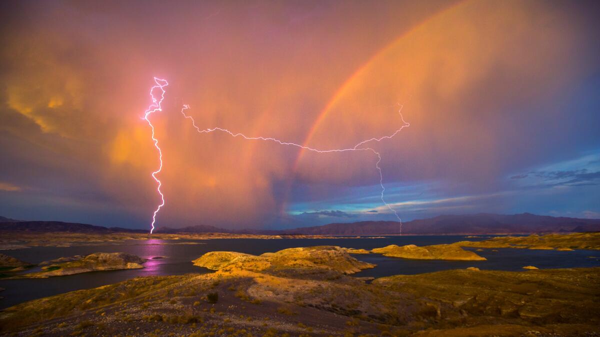 Lighting and a rainbow create a show over Lake Mead in 2015.