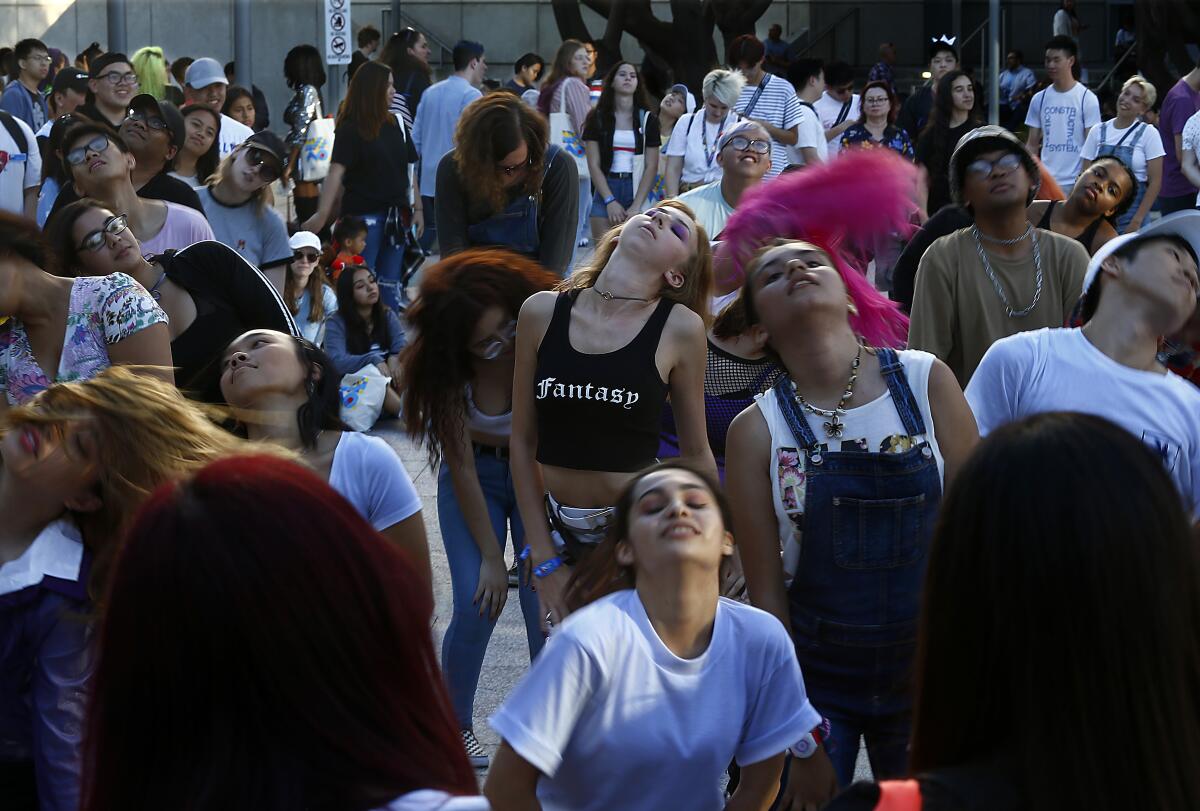 K-pop fans get together to dance outside Staples Center before KCON in Los Angeles on Saturday.  