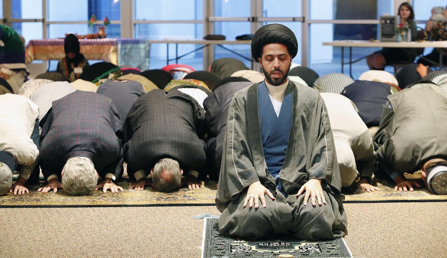 Imam Mahdi al-Qazwini leads a Muslim prayer at the Temple Bat Yahm synagogue in Newport Beach on Thursday during a multi-faith gathering for iftar, a fast-breaking dinner during Ramadan, the Muslim holy month.