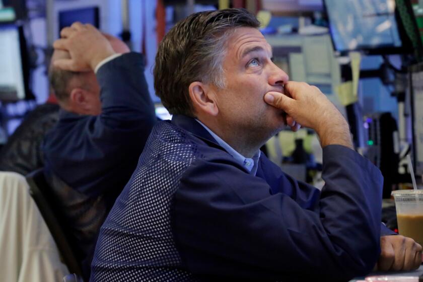 Trader Jeffrey Lucchesi works on the floor of the New York Stock Exchange on June 27.