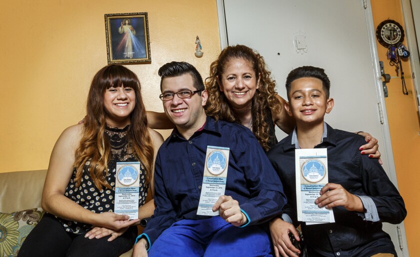 Elsa Gonzalez and her children, Dulce Maria, Christian and Edwin, holding three tickets for Pope Francis' visit to Washington.