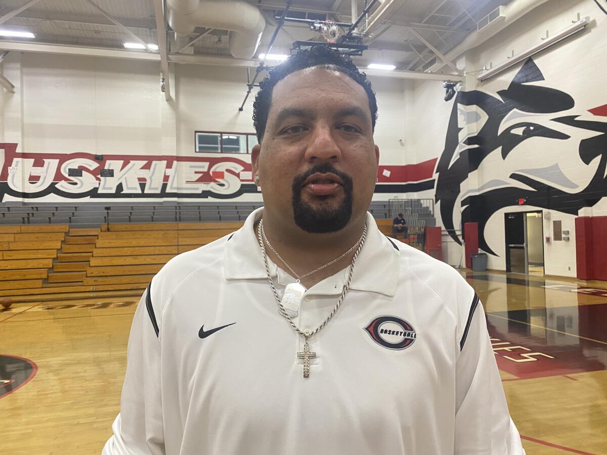 Corona Centennial girls' basketball coach Martin Woods poses for a photo.