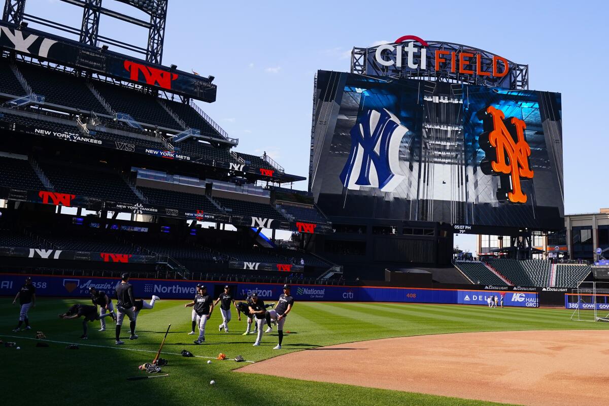 The New York Yankees warm up before a baseball game against the New York Mets at Citi Field 