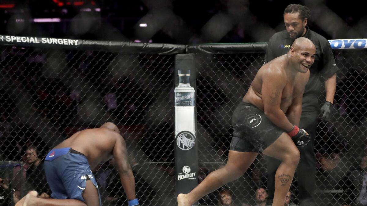 Daniel Cormier, right, reacts after defeating Derrick Lewis by submission during the second round of a heavyweight mixed martial arts bout at UFC 230.