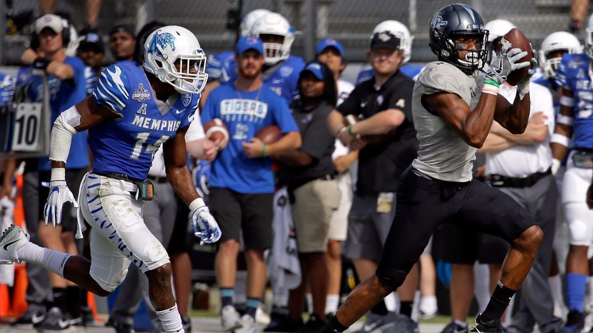 Central Florida wide receiver Tre'Quan Smith, right, catches a pass in front of Memphis defensive back Jonathan Cook for a 50-yard touchdown during the first half of the American Athletic Conference championship on Saturday.