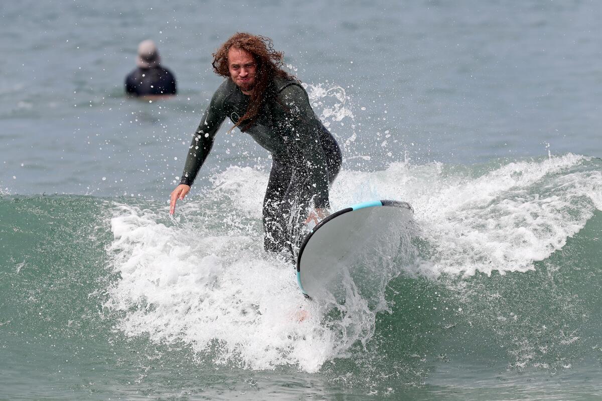 Mr. Irrelevant Grant Stuard wipes out during surfing lessons, as part of the Irrelevant Week festivities.