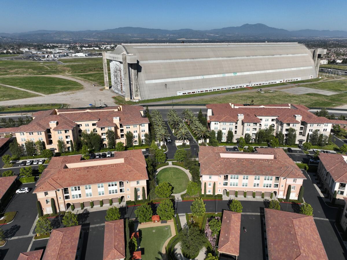 An aerial view of housing in Tustin. In the background is the World War II-era Tustin Hangar 2.