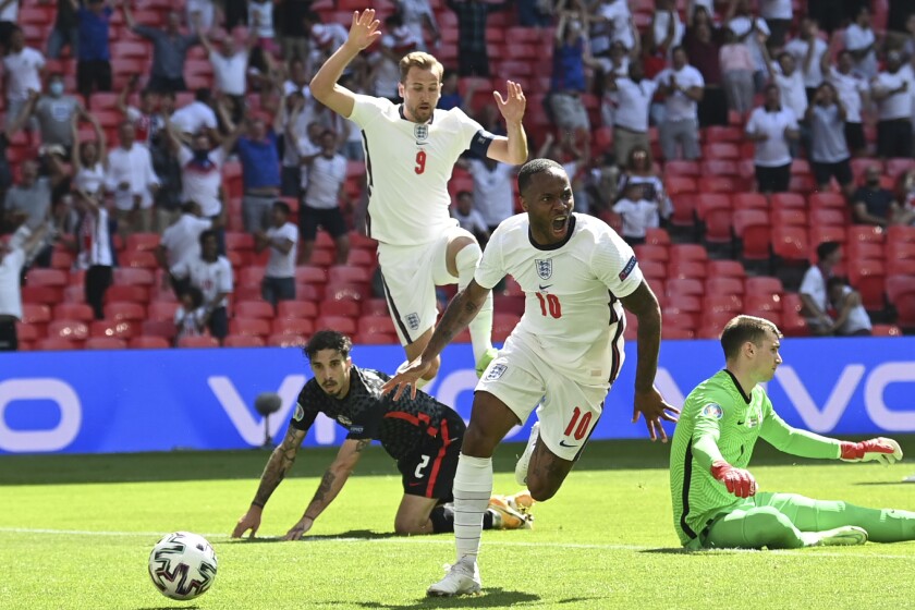 England's Raheem Sterling celebrates after scoring his side's opening goal during the Euro 2020 soccer championship group D match between England and Croatia at Wembley stadium in London, Sunday, June 13, 2021. (Glyn Kirk/Pool Photo via AP)