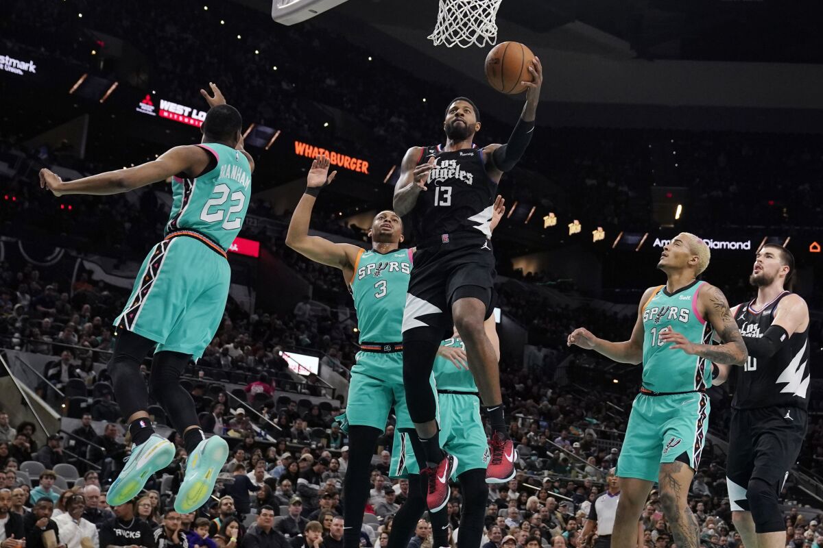 The Clippers' Paul George scores past the Spurs' Keldon Johnson (3) during the second half Jan. 20, 2023.