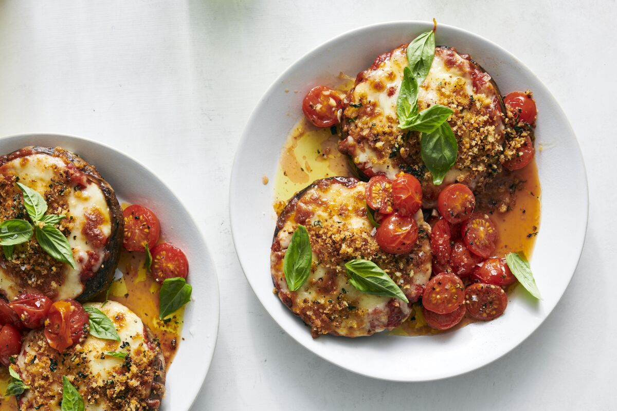 Portobello mushrooms made into a classic Parm dish, topped with cherry tomatoes and basil.