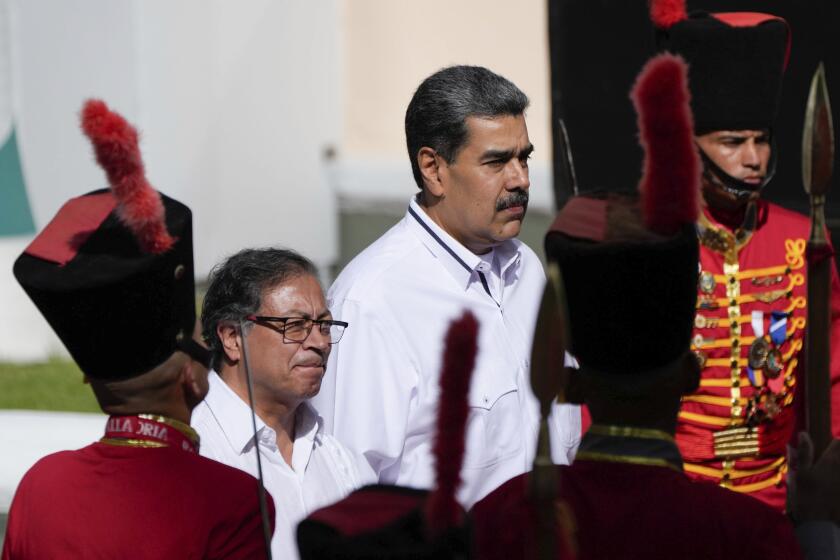 FILE - Venezuelan President Nicolas Maduro, right, stands with Colombian President Gustavo Petro after Petro arrived at Miraflores presidential palace in Caracas, Venezuela, Saturday, Nov. 18, 2023. (AP Photo/Ariana Cubillos, File)