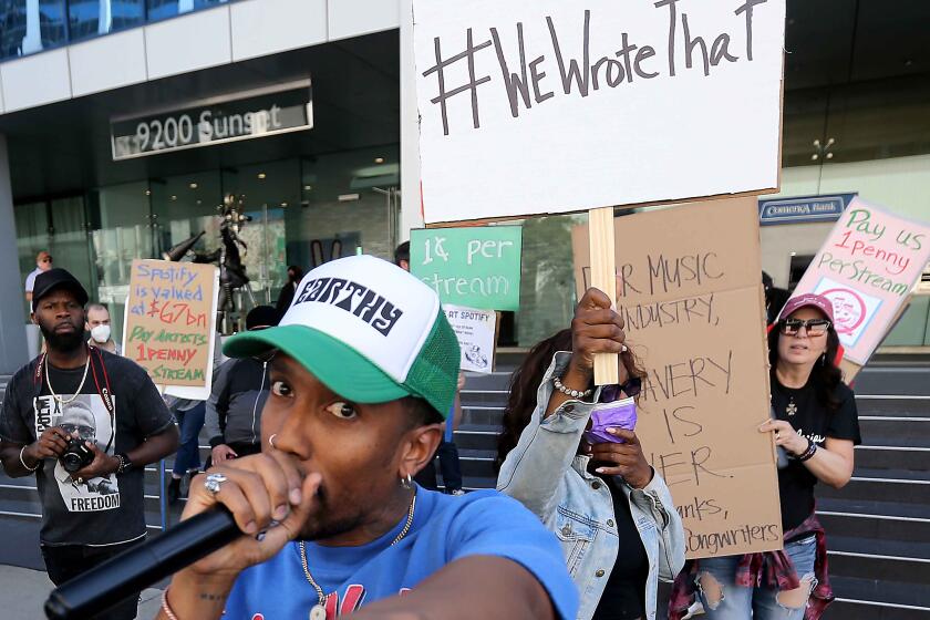 WEST HOLLYWOOD, CALIF. - FEB. 28,2022. Micah Powell breaks into a rap about Spotify's need to pay artists more during a protest outside the streaming service's offices on Sunset Boulevard in West Hollywood on Monday. Feb. 28, 2022. (Luis Sinco / Los Angeles Times)