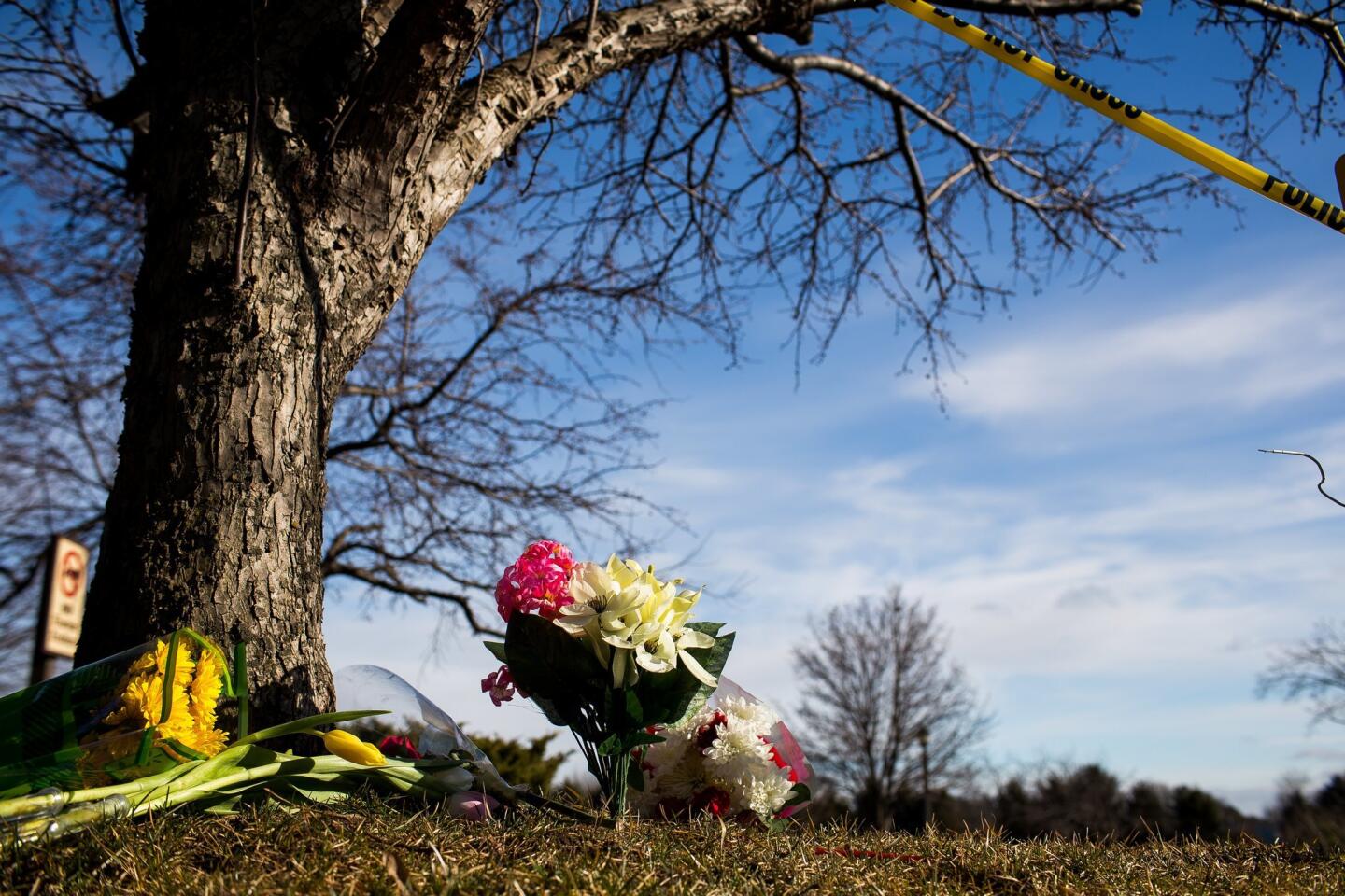 Flowers lie near a makeshift memorial outside a Cracker Barrel restaurant in Kalamazoo, Mich. According to police, a man drove around Kalamazoo fatally shooting several people at multiple locations on Saturday, including the parking lot of the restaurant. Authorities identified the shooter as Jason Dalton.
