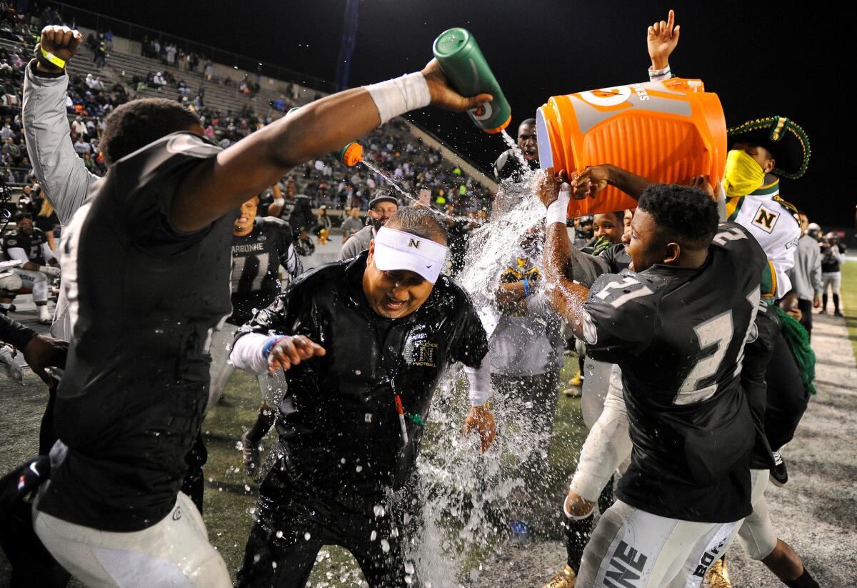 Narbonne coach Manuel Douglas gets doused with water by his players after beating Crenshaw.