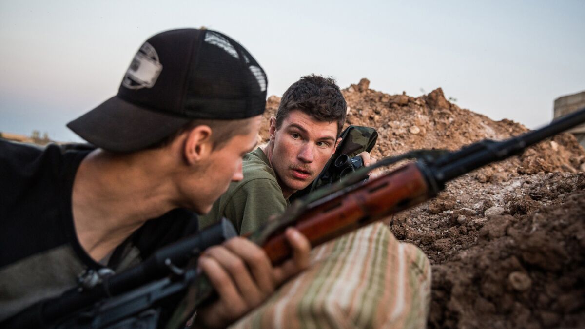 Levi Shirley, right, and another American volunteer during a clash with Islamic State fighters near Tal Tamr, Syria.