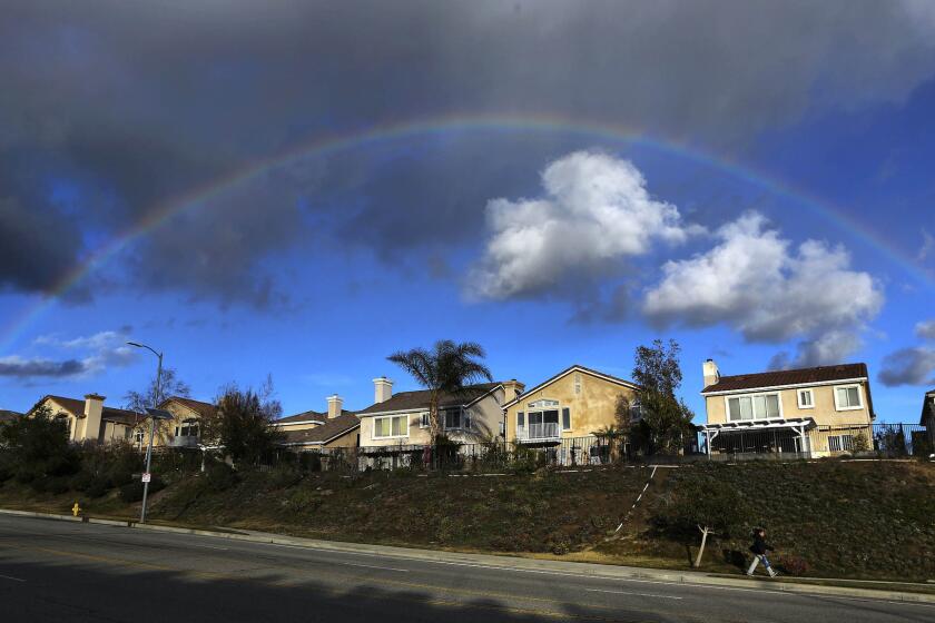 A rainbow forms over homes on Porter Ranch Drive in Porter Ranch on Jan. 7, 2016.