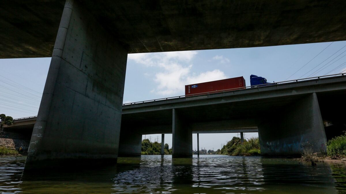 A tractor-trailer drives along the 405 Freeway interchange and connectors as it passes over the San Gabriel River near Seal Beach.