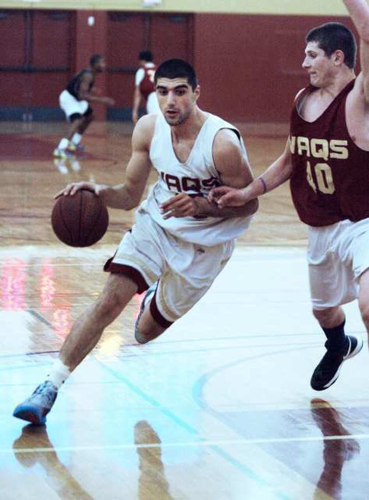 Gor Plavchyan drives against Nick Khan at Glendale Community College men's basketball practice.