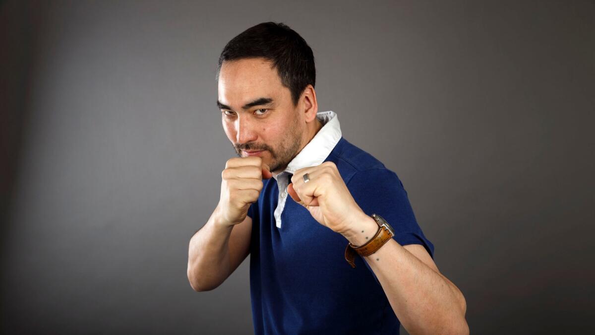 Professor and author Tim Wu, who coined the term network neutrality in 2003, stands for a portrait during the Los Angeles Times Festival of Books on April 23, 2017. (Patrick T. Fallon / For The Times)