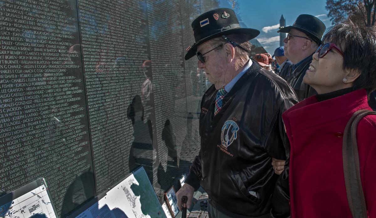 War author and correspondent Joseph Galloway and his wife, Grace, at the Vietnam Veterans Memorial wall in 2013.