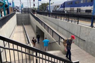 Passengers use the tunnel beneath the tracks Monday at the Oceanside Transit Center, where an art project is planned.
