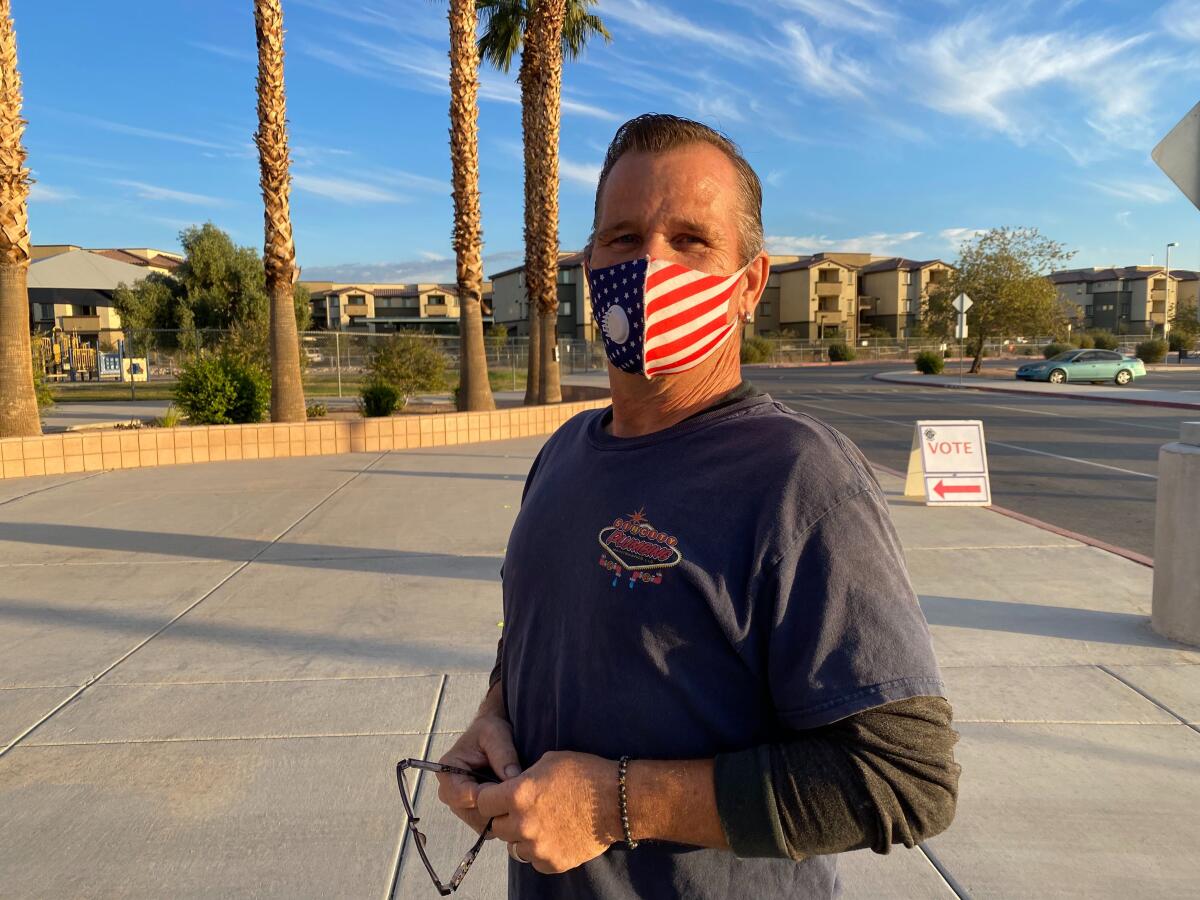 Voter Randall Norvell, in a U.S. flag-inspired mask, stands outside a Las Vegas polling place.