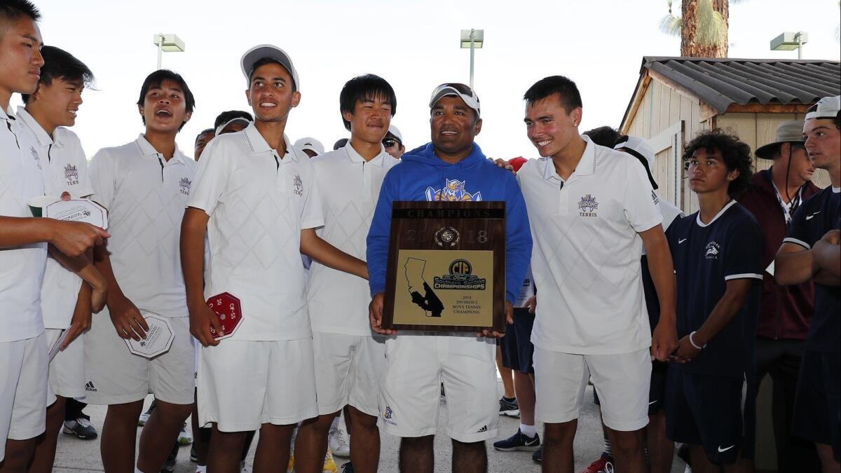 Fountain Valley High coach Harshul Patel holds the championship plaque after the Barons defeated Temecula Great Oak 11-7 in the CIF Southern Section Division 2 final at The Claremont Club on May 18.