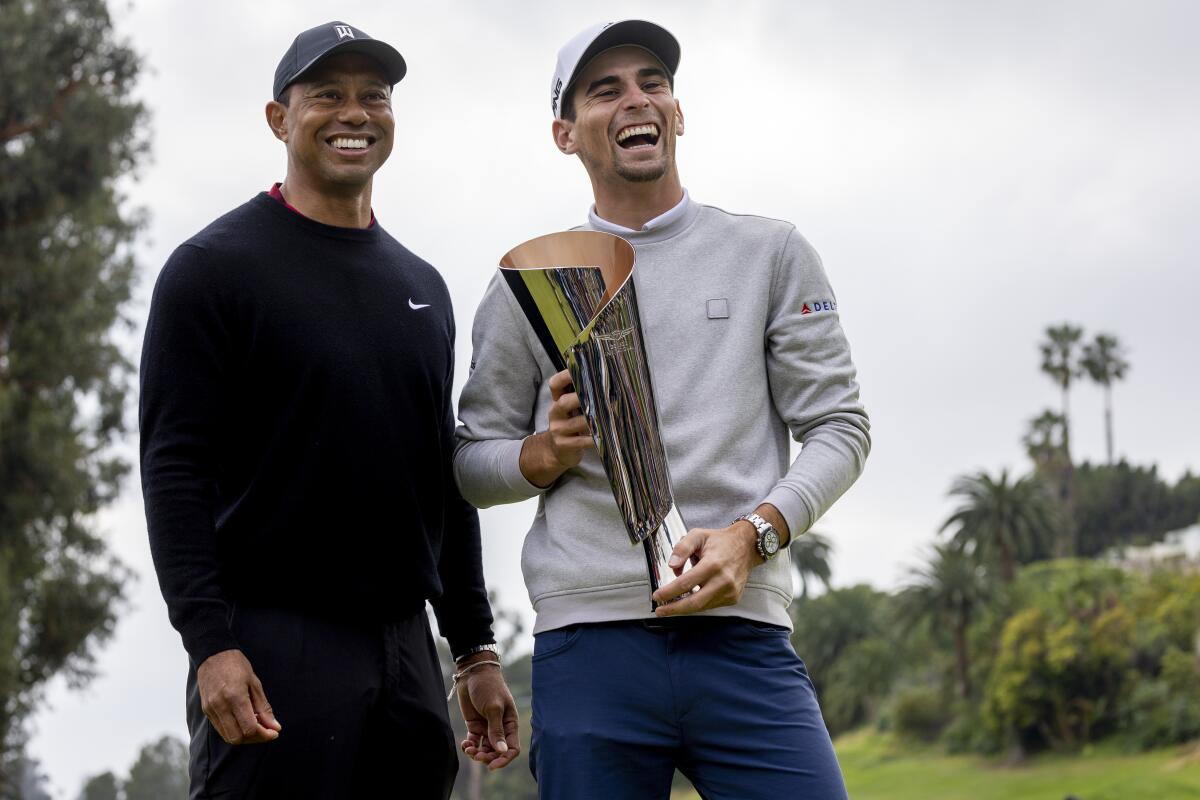 Genesis Invitational winner Joaquin Niemann shares a laugh with tournament host Tiger Woods.