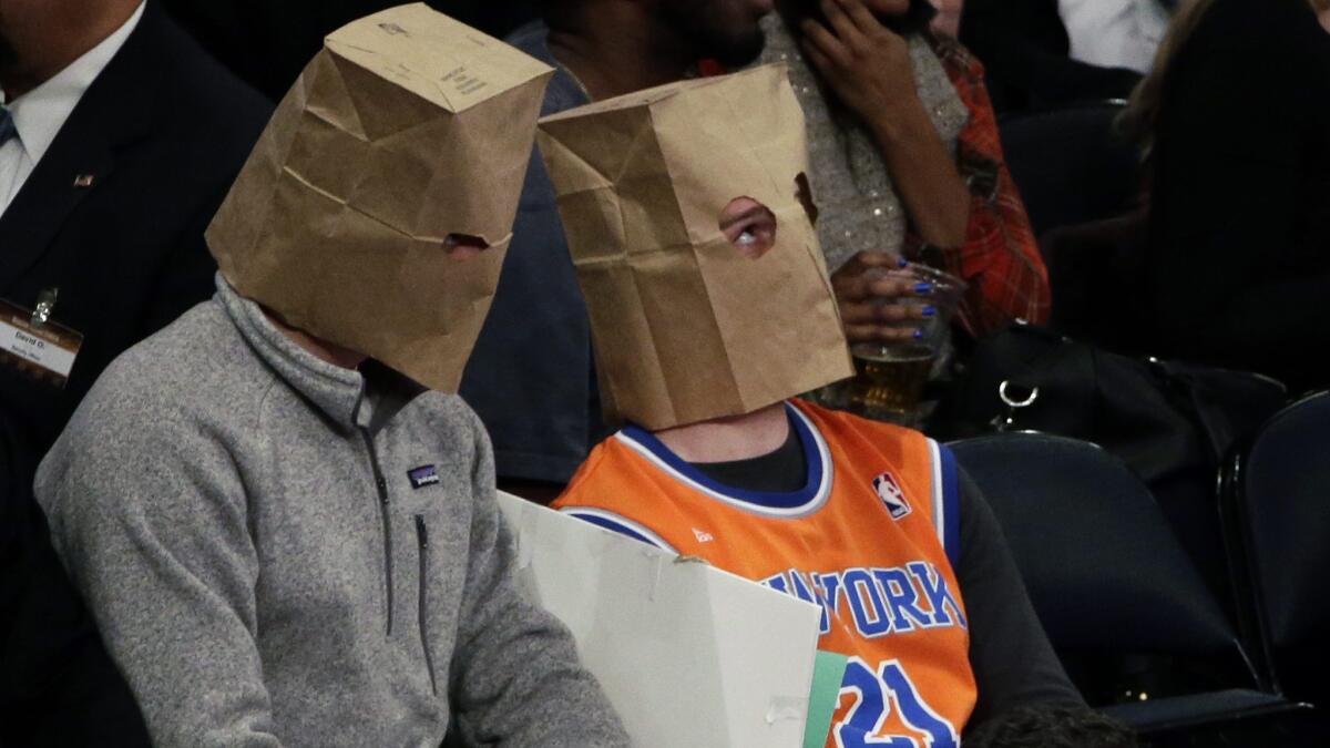 Frustrated New York Knicks fans cover their faces with paper bags during a game against the Houston Rockets at Madison Square Garden on Jan. 8.