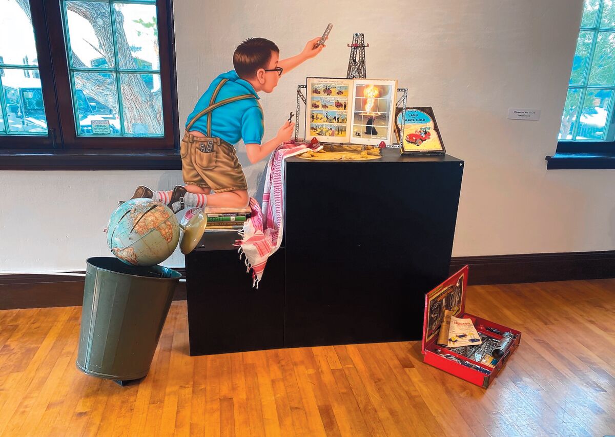 'Global Mishap' is one of the 12 life-size installations in 'Stories of Innocence and Experience.' A boy intent on building an oil derrick with his Erector Set - a popular toy in the 1950s - is carelessly knocking over the globe into a school trashcan.